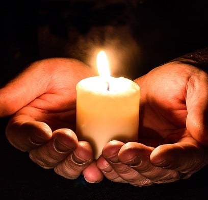 hands holding candle