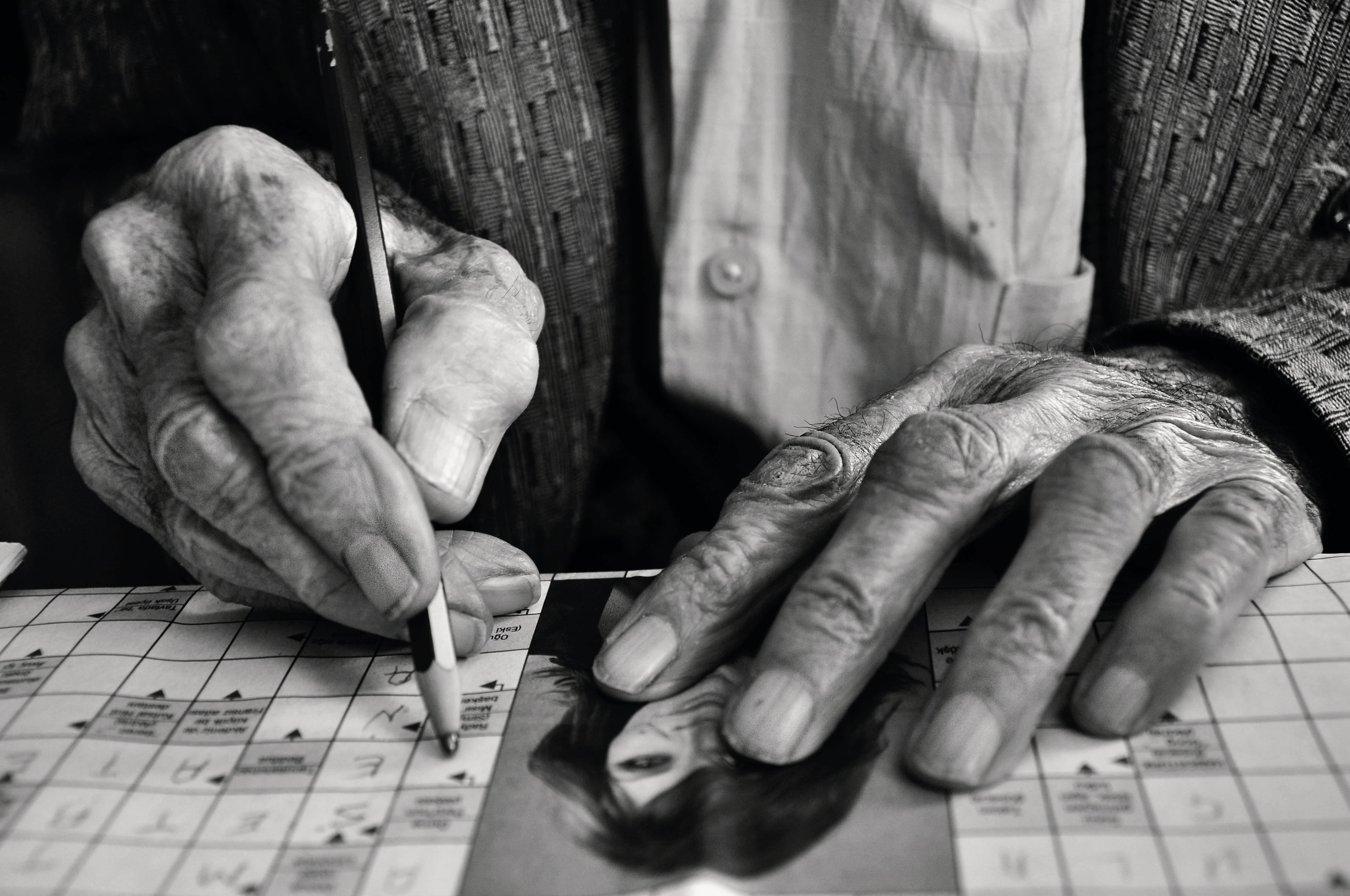 black and white photo close-up of a man playing bingo